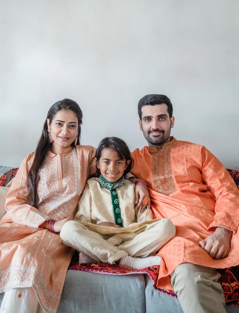 Happy Indian family sitting together at home