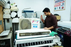 Technician servicing a split air conditioner indoor unit