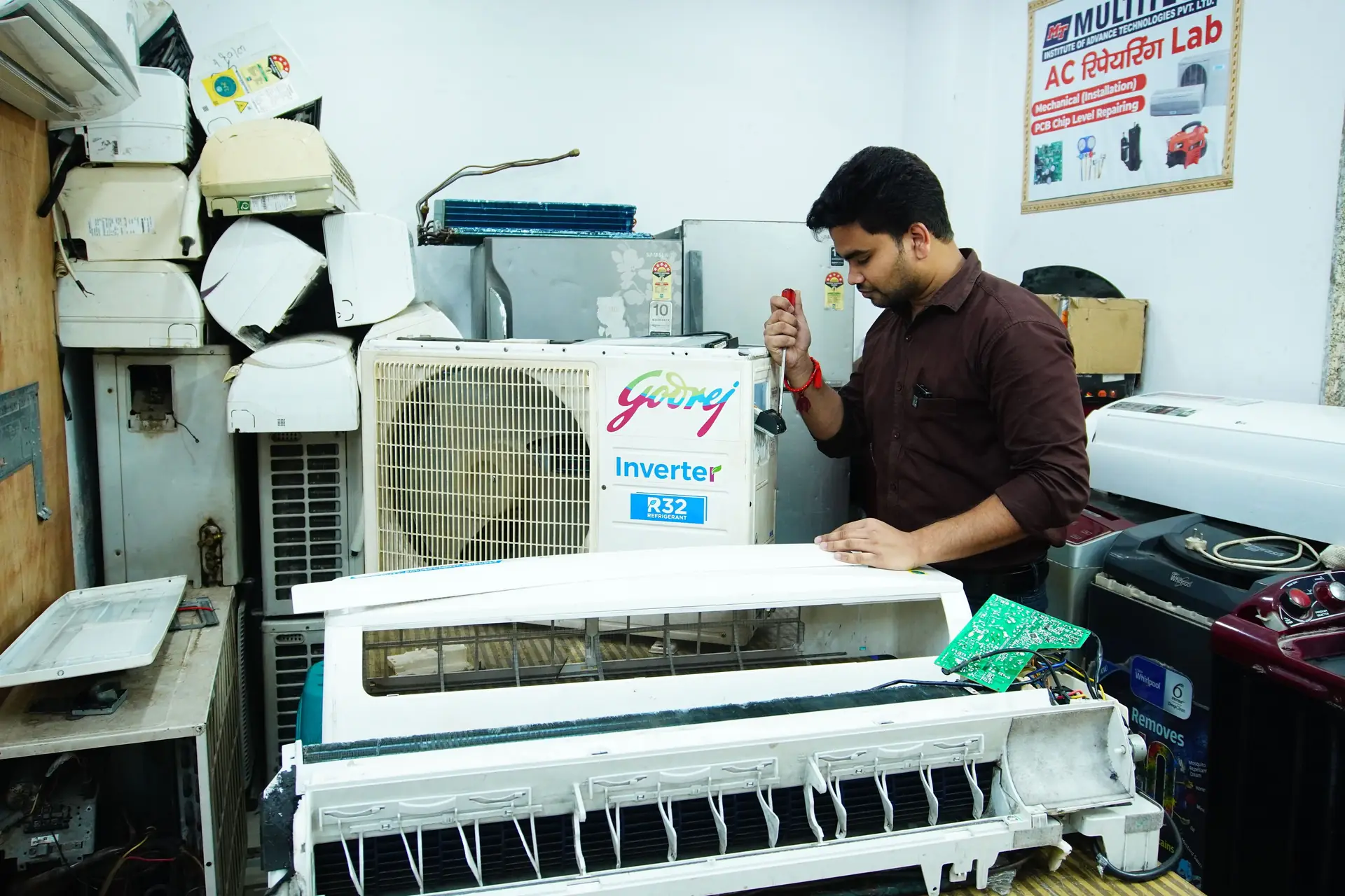 Technician servicing a split air conditioner indoor unit