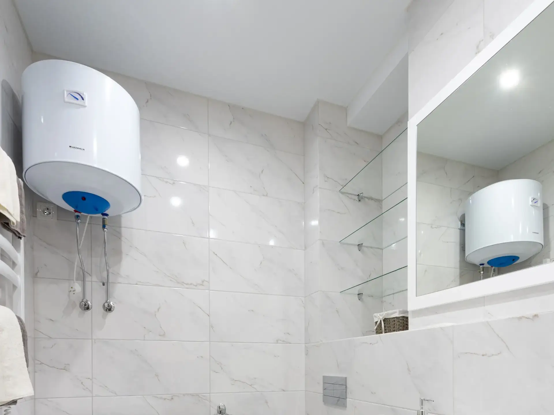 Wall-mounted water geyser in a modern bathroom