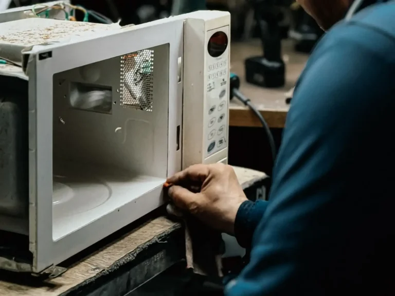 Technician repairing a microwave oven