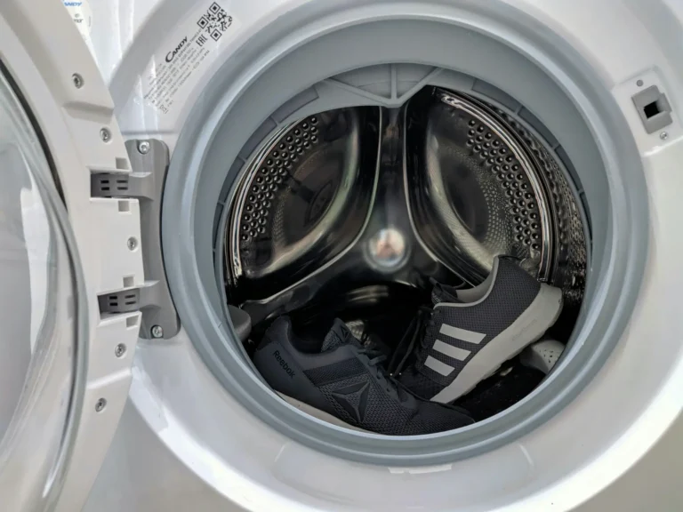 Front-load washing machine with the door open, drum visible